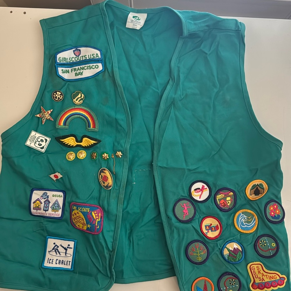 Girl Scouts vest with patches and pins